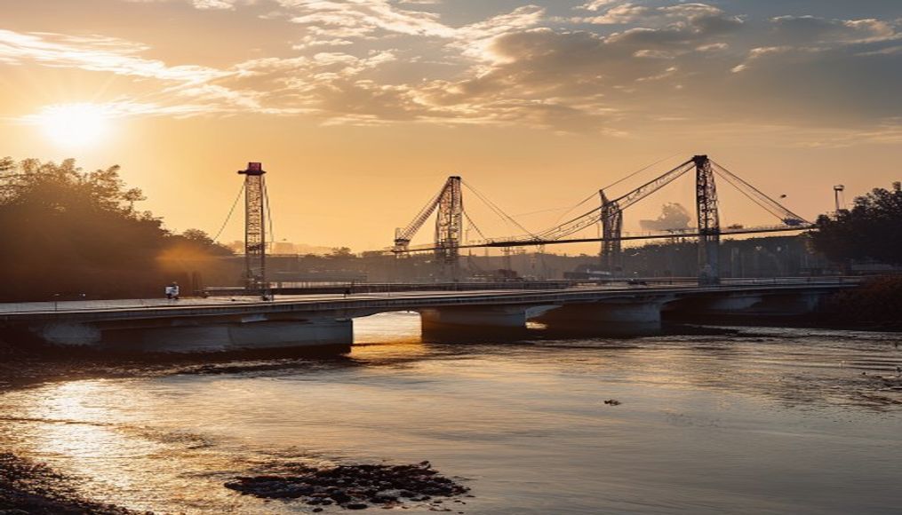 Bridge construction site with cranes over river em estilo editorial